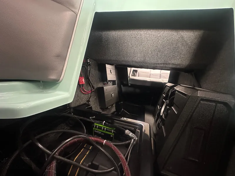 Slide: The Image of 2025 Moomba Max interior storage compartment with wiring and equipment. - 21