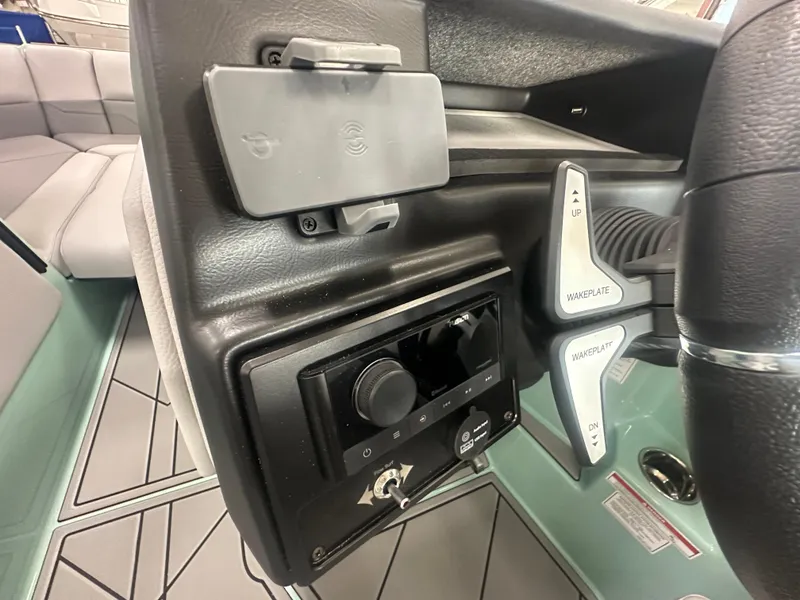 Slide: The Image of 2025 Moomba Max boat dashboard with controls and steering wheel. - 27