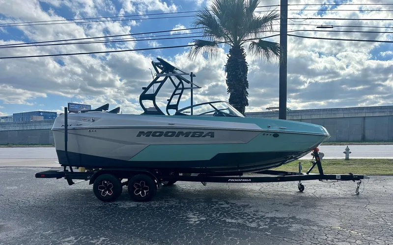 Slide: The Image of 2025 Moomba Max boat on trailer, parked outdoors under cloudy sky. - 3