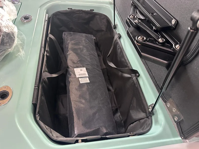 Slide: The Image of 2025 Moomba Max storage compartment with black interior and organized space. - 35