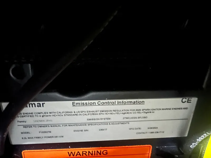 Slide: The Image of Emission control label on 2025 Moomba Max engine with warning notice. - 38