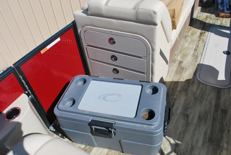 Slide: The Image of 2024 Crest Classic Platinum 240 SLC interior with storage and cooler. - 11