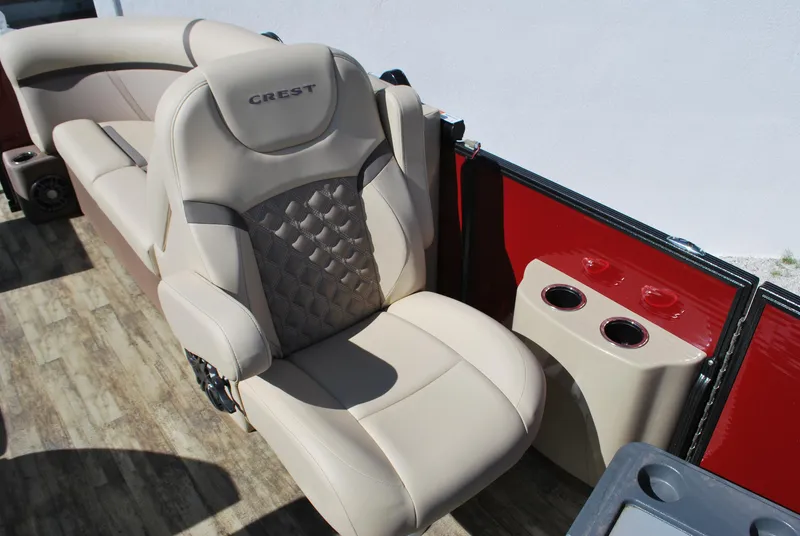Slide: The Image of 2024 Crest Classic Platinum 240 SLC boat seat with cup holders, beige upholstery. - 12