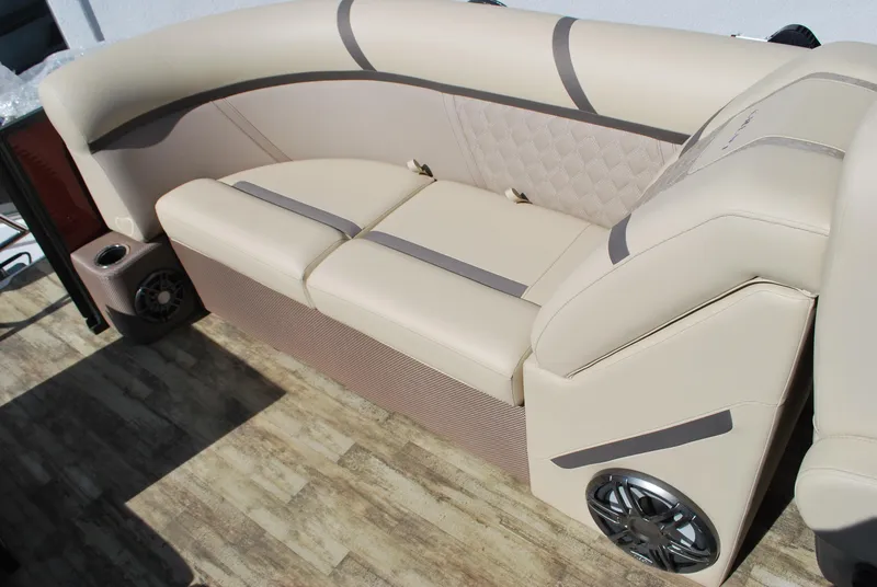 Slide: The Image of 2024 Crest Classic Platinum 240 SLC boat seating with beige upholstery and built-in speakers. - 13