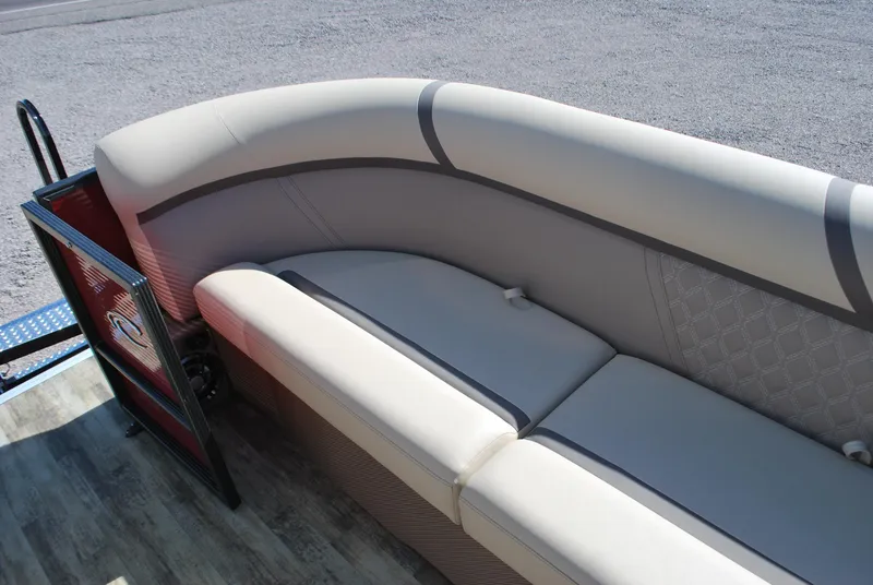 Slide: The Image of 2024 Crest Classic Platinum 240 SLC boat interior with beige seating. - 6