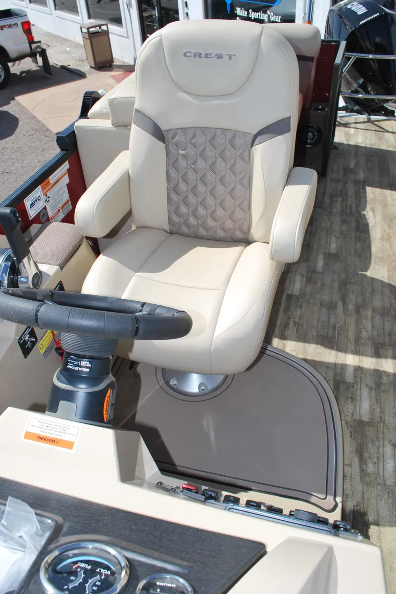 Slide: The Image of 2024 Crest Classic Platinum 240 SLC captain's chair and helm, featuring luxurious design. - 8