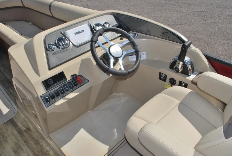 Slide: The Image of 2024 Crest Classic Platinum 240 SLC boat interior with steering wheel and control panel. - 9