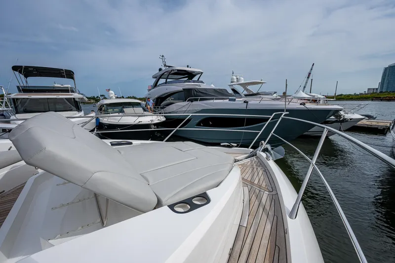 Slide: The Image of 2022 Sunseeker Manhattan 68 yacht docked at marina, showcasing sleek design and luxury features. - 19