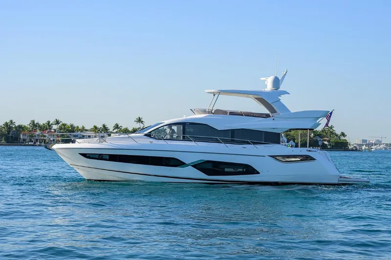 Slide: The Image of 2022 Sunseeker Manhattan 68 yacht cruising on calm blue waters. - 2