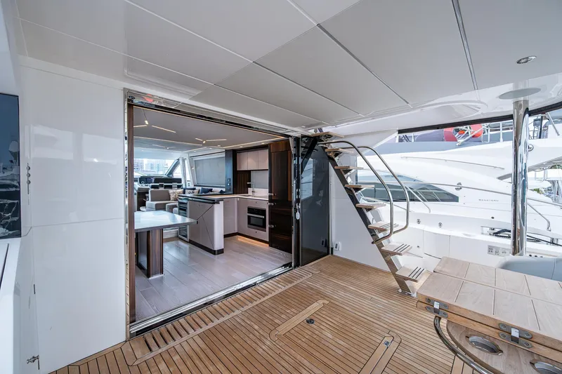 Slide: The Image of Luxurious Sunseeker Manhattan 68 yacht interior, featuring modern kitchen and elegant wooden deck, 2022 model. - 20