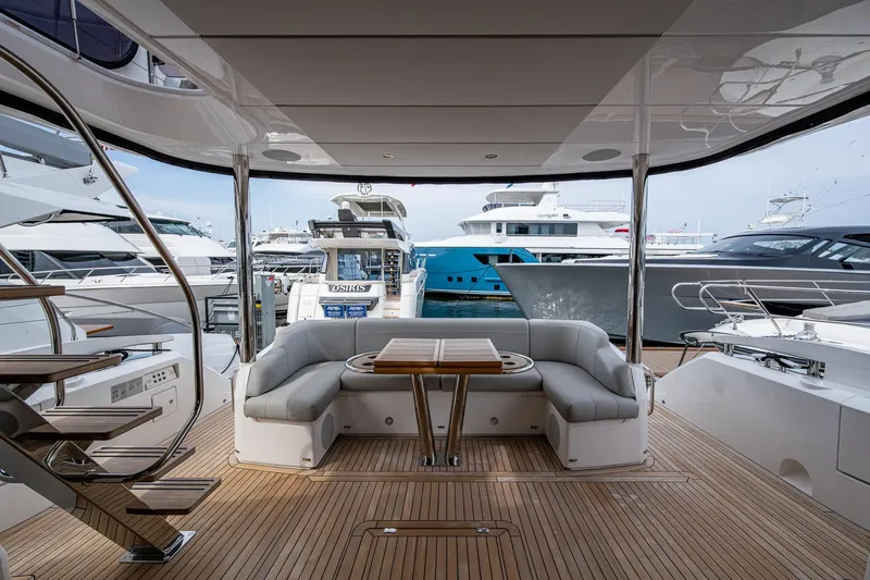 Slide: The Image of 2022 Sunseeker Manhattan 68 yacht interior with elegant seating and wooden deck. - 24
