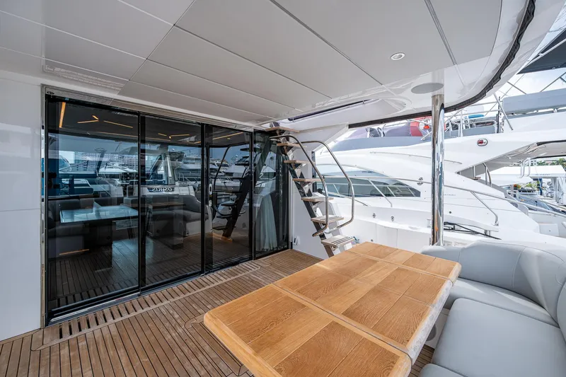 Slide: The Image of Luxurious Sunseeker Manhattan 68 yacht deck with wooden table and modern seating, 2022 model. - 26