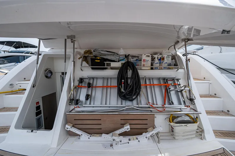 Slide: The Image of Storage compartment on a 2022 Sunseeker Manhattan 68 yacht, featuring organized equipment and supplies. - 29