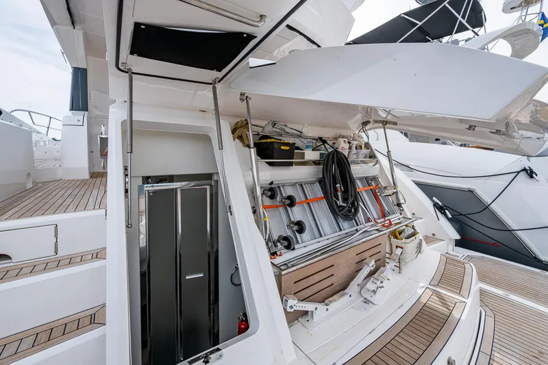 Slide: The Image of Sunseeker Manhattan 68 yacht, 2022 model, showcasing open storage compartment and deck area. - 30