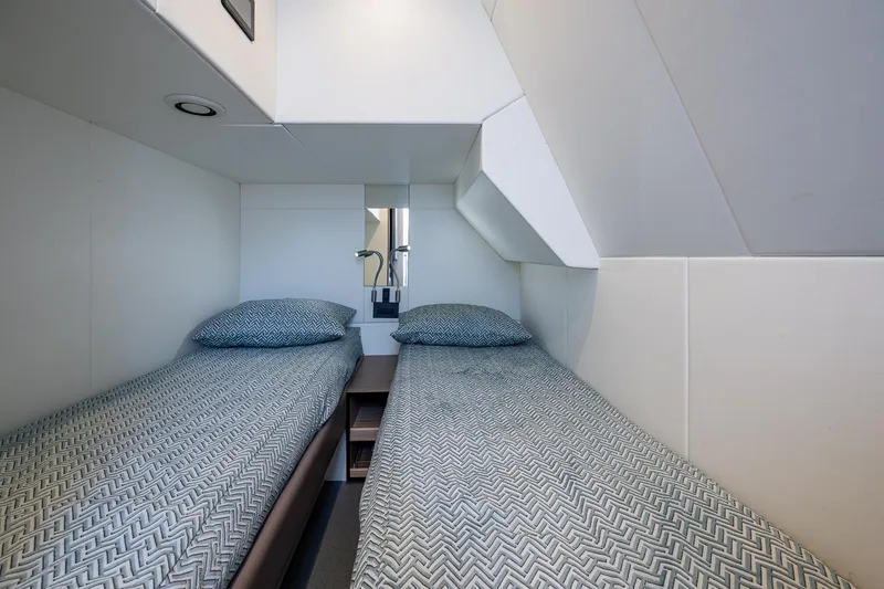 Slide: The Image of Twin cabin in 2022 Sunseeker Manhattan 68 yacht, featuring modern bedding and sleek design. - 34