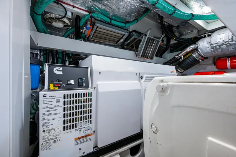 Slide: The Image of Engine room of 2022 Sunseeker Manhattan 68 yacht with Cummins generator and mechanical components. - 41