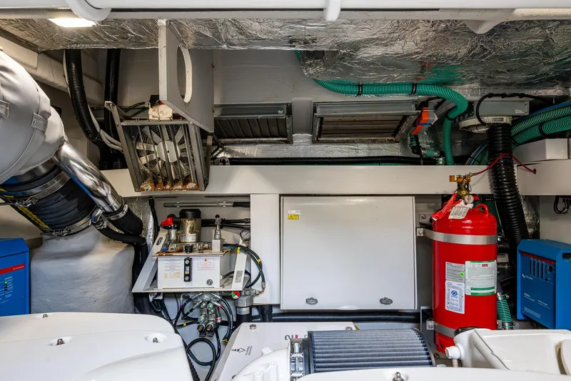 Slide: The Image of Engine room of 2022 Sunseeker Manhattan 68 yacht, featuring equipment and fire extinguisher. - 44