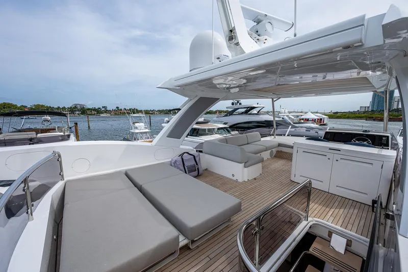 Slide: The Image of Luxurious Sunseeker Manhattan 68 yacht deck with seating, 2022 model, docked by the water. - 45