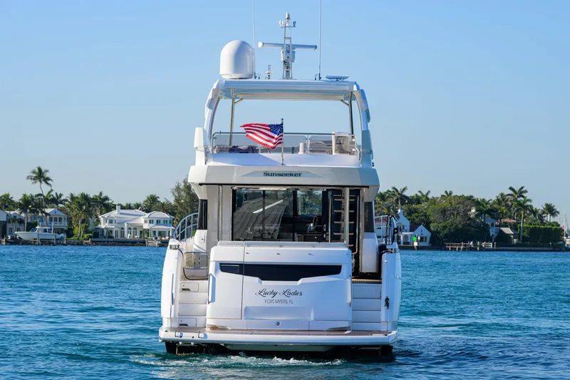 Slide: The Image of 2022 Sunseeker Manhattan 68 yacht on water, rear view with American flag. - 6