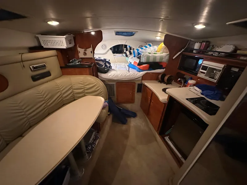 Slide: The Image of Interior of 2003 Rinker Fiesta Vee 312 boat with cozy seating and kitchenette. - 16