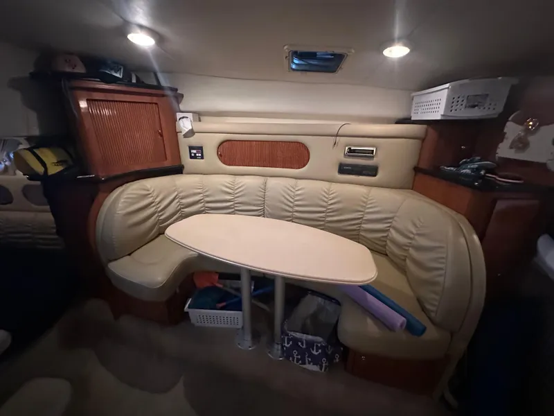 Slide: The Image of 2003 Rinker Fiesta Vee 312 cabin interior with cozy seating and table. - 18