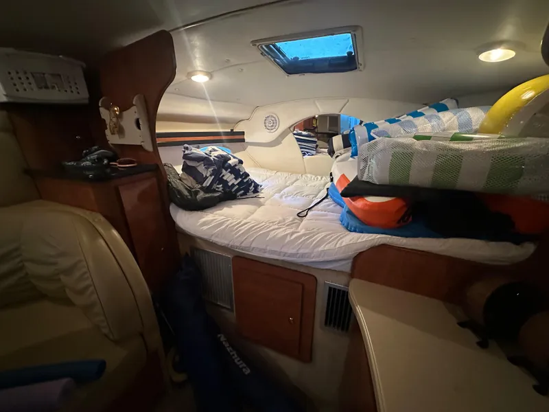 Slide: The Image of Interior cabin of 2003 Rinker Fiesta Vee 312 boat with cozy bedding. - 20