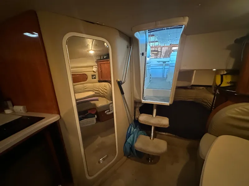 Slide: The Image of Interior of 2003 Rinker Fiesta Vee 312 boat, featuring cozy cabin and seating area. - 22