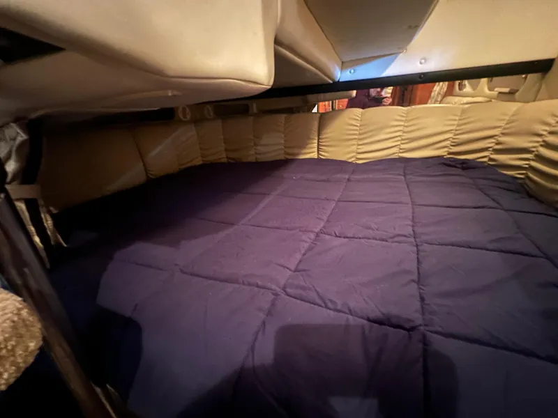Slide: The Image of Interior cabin of 2003 Rinker Fiesta Vee 312 with blue bedding. - 24