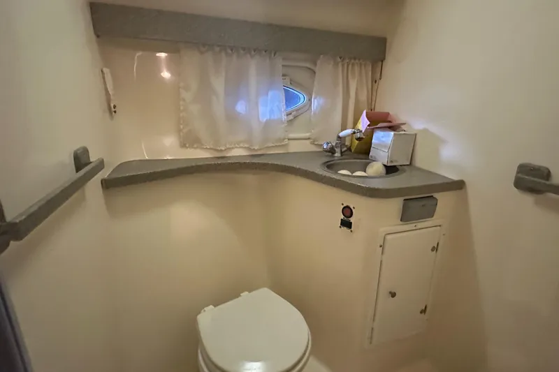 Slide: The Image of 2003 Rinker Fiesta Vee 312 boat bathroom with sink and toilet. - 25