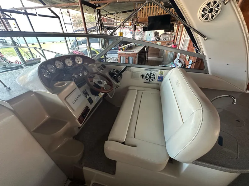 Slide: The Image of 2003 Rinker Fiesta Vee 312 boat cockpit with steering wheel and control panel. - 4
