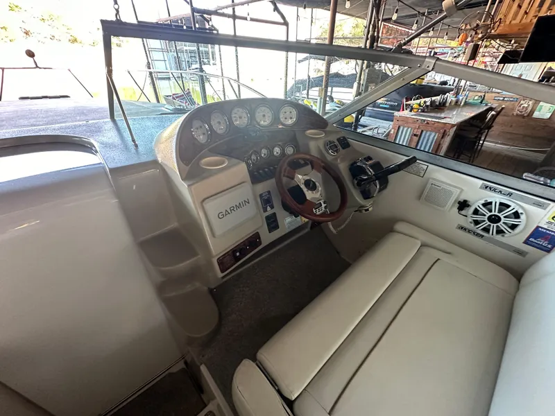 Slide: The Image of 2003 Rinker Fiesta Vee 312 boat cockpit with Garmin navigation system and steering wheel. - 5