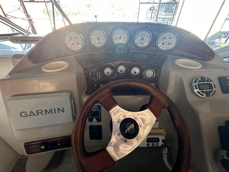 Slide: The Image of 2003 Rinker Fiesta Vee 312 dashboard with Garmin navigation system and gauges. - 7