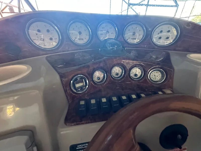 Slide: The Image of Dashboard of 2003 Rinker Fiesta Vee 312 boat with gauges and controls. - 9