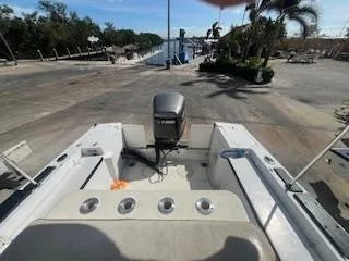 Slide: The Image of 1985 Mako 21B boat with Yamaha outboard motor at a marina dock. - 2