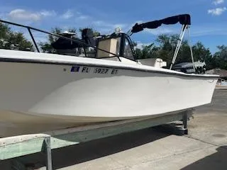 Slide: The Image of 1985 Mako 21B boat on trailer, white hull, outdoor setting. - 3