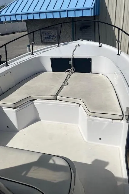 Slide: The Image of 1985 Mako 21B boat interior with cushioned seating and metal railings. - 4