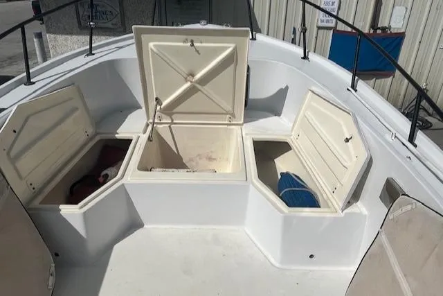 Slide: The Image of 1985 Mako 21B boat with open storage compartments on deck. - 5