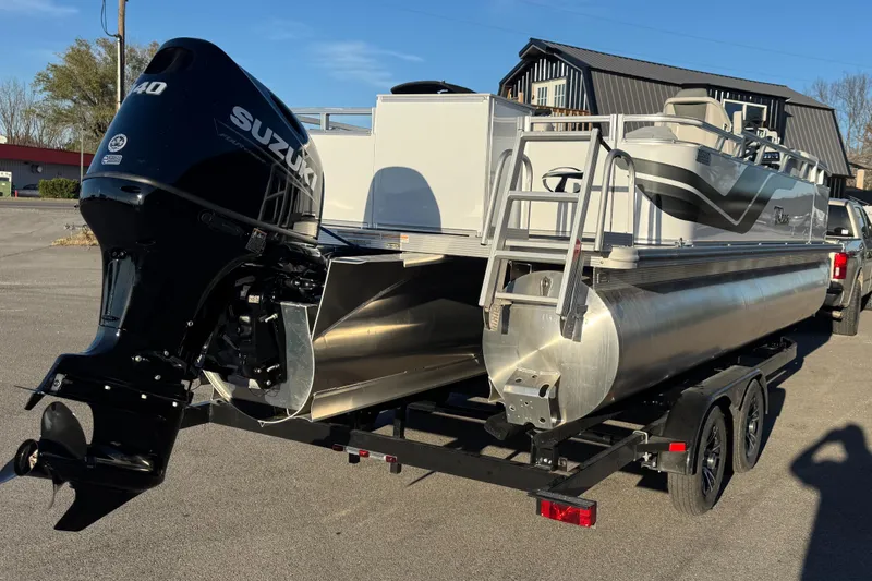 Slide: The Image of 2025 Tahoe Pontoon SP 2180 FNC with Suzuki engine on trailer. - 1