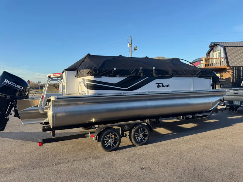 Slide: The Image of 2025 Tahoe Pontoon SP 2180 FNC on trailer, covered, with Suzuki outboard motor. - 2