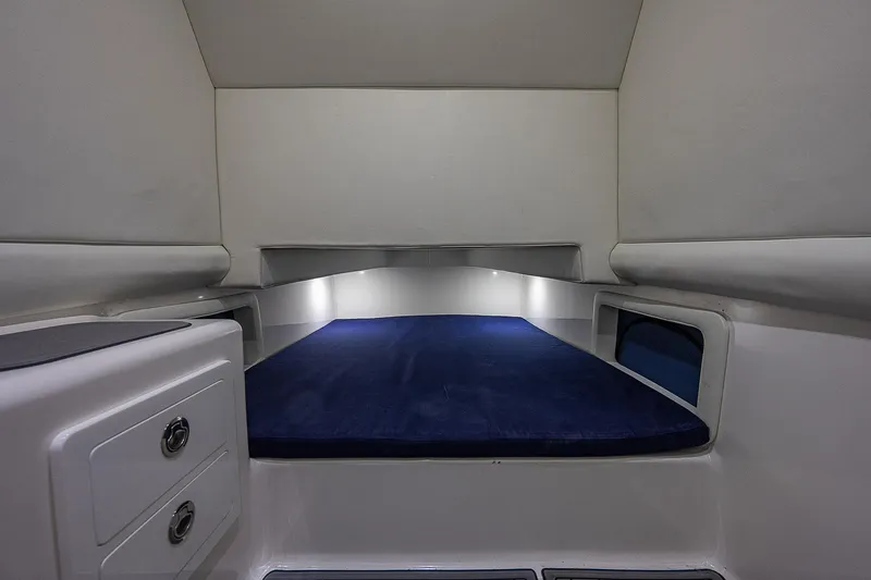 Slide: The Image of Interior cabin of 2021 Front Runner 39 Center Console boat, featuring a cozy sleeping area. - 21