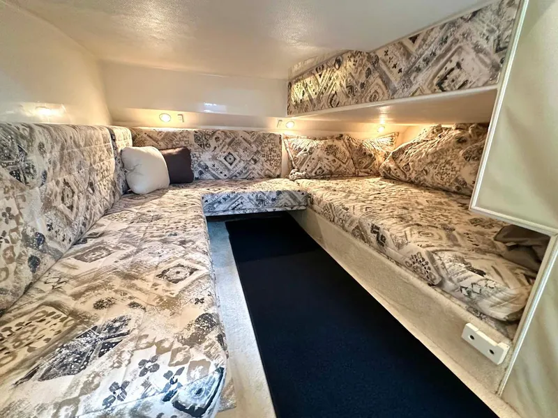 Slide: The Image of 1999 Wellcraft 45 Excalibur cabin interior with patterned upholstery and cozy lighting. - 13