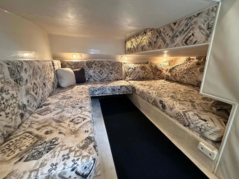 Slide: The Image of 1999 Wellcraft 45 Excalibur cabin interior with patterned upholstery and ambient lighting. - 14