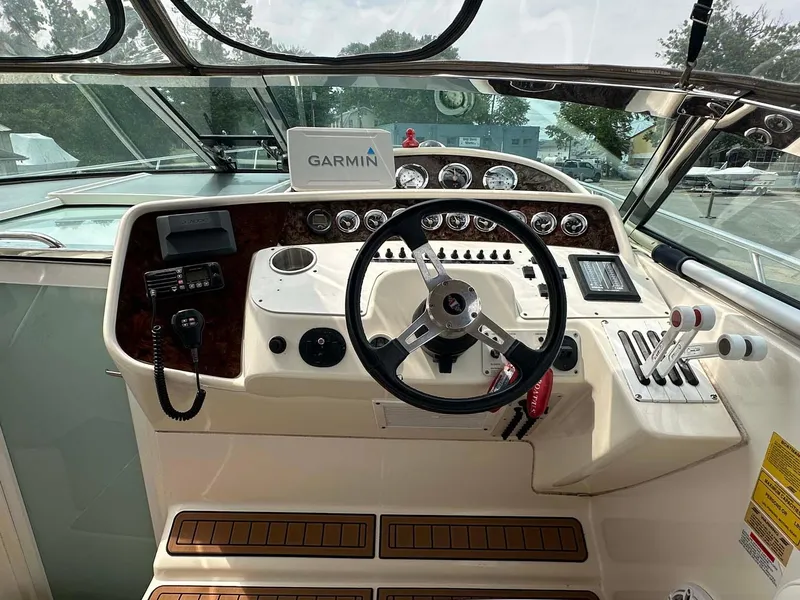 Slide: The Image of 1999 Wellcraft 45 Excalibur boat dashboard with Garmin navigation system and controls. - 17