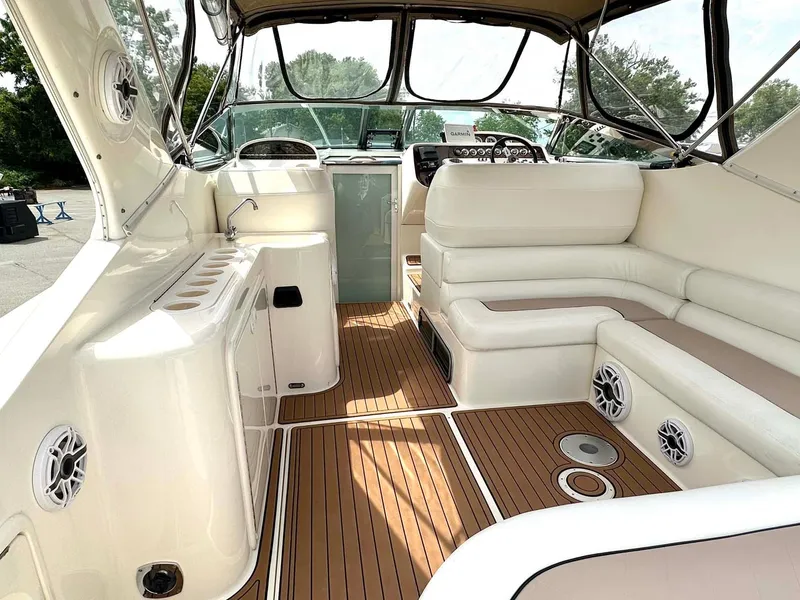 Slide: The Image of Interior of 1999 Wellcraft 45 Excalibur boat with white seating and wood flooring. - 24