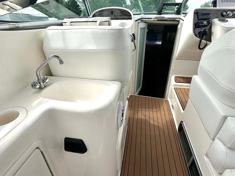 Slide: The Image of Interior of 1999 Wellcraft 45 Excalibur boat with sink and wooden flooring. - 25