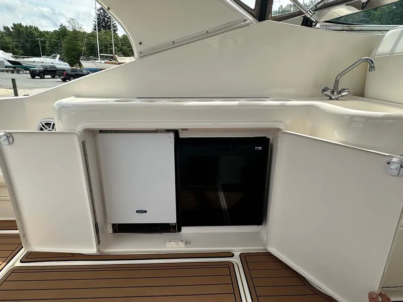 Slide: The Image of 1999 Wellcraft 45 Excalibur yacht interior with open cabinets and sink. - 26