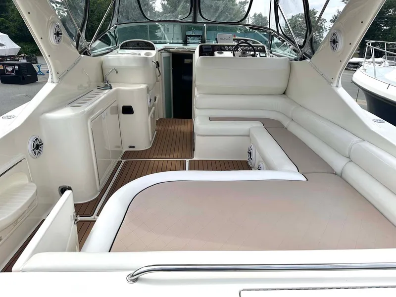 Slide: The Image of 1999 Wellcraft 45 Excalibur boat interior with white seating and wood flooring. - 27