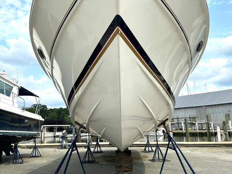 Slide: The Image of 1999 Wellcraft 45 Excalibur boat on stands at a marina, viewed from the bow. - 32