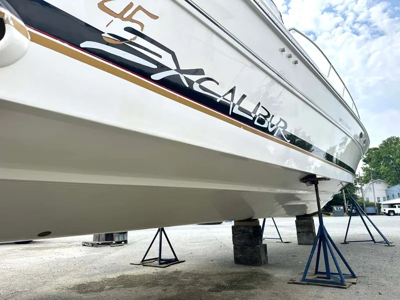 Slide: The Image of 1999 Wellcraft 45 Excalibur boat on stands, side view. - 34