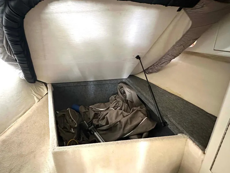 Slide: The Image of Storage compartment in 1999 Wellcraft 45 Excalibur boat, featuring fabric and equipment. - 39